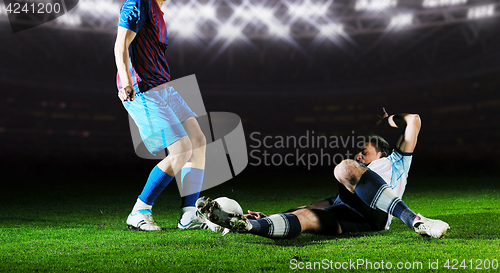 Image of football players in competition for the ball