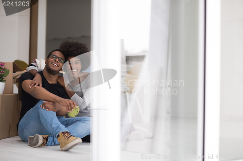 Image of African American couple relaxing in new house