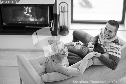 Image of Young couple  in front of fireplace