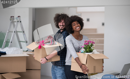 Image of multiethnic couple moving into a new home