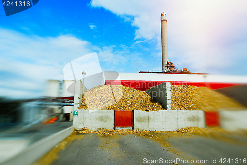 Image of blurred bio power plant with storage of wooden fuel (biomass) ag