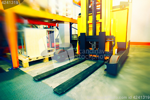 Image of Shelves, racks and forklift blured with pallets in distribution 