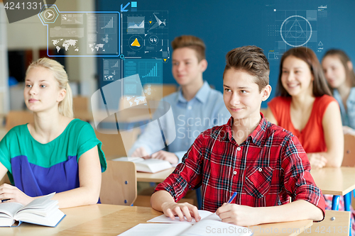 Image of group of students with notebooks at school lesson