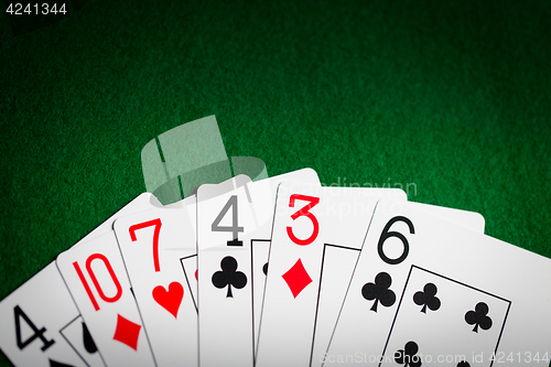 Image of poker hand of playing cards on green casino cloth