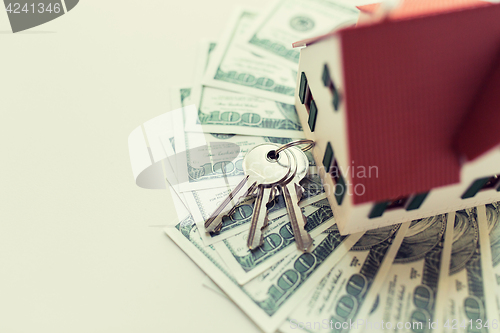 Image of close up of home model, money and house keys