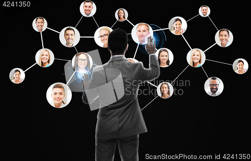 Image of businessman working with network contacts icons