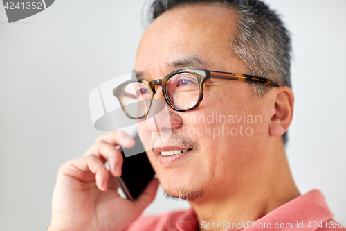 Image of close up of man calling on smartphone at home