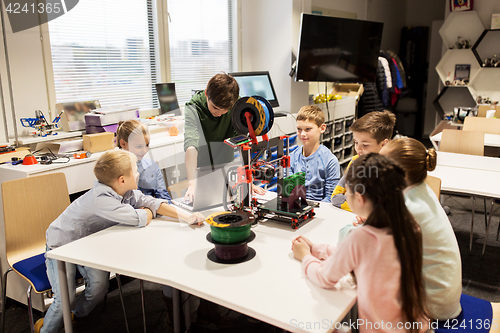 Image of happy children with 3d printer at robotics school