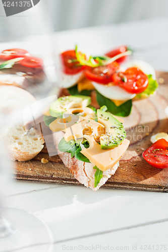 Image of The baguette and cheese on wooden background