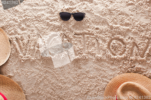 Image of vacation written in a sandy tropical beach