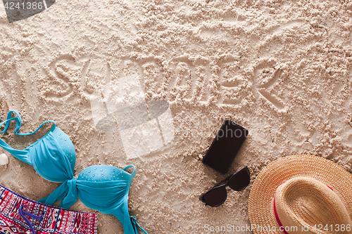 Image of Summer written in a sandy tropical beach