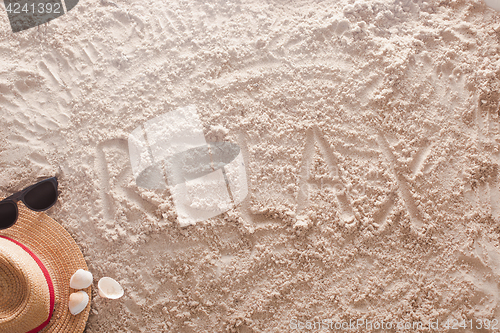 Image of Relax written in a sandy tropical beach