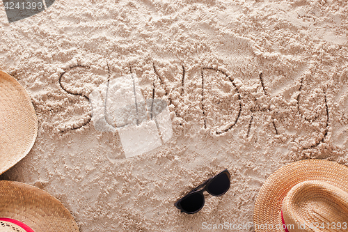 Image of Sunday written in a sandy tropical beach