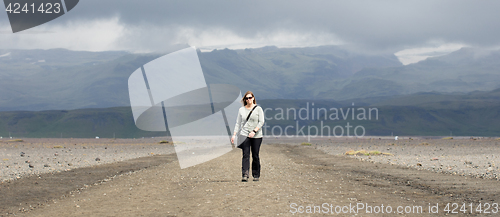 Image of Woman hiker walking in mountain landscape