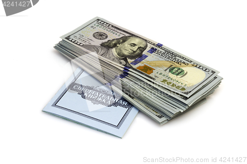 Image of One hundred dollars banknotes lie on checkbook isolated on white background