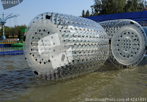 Image of Zorbing. Runs inside a transparent sphere.