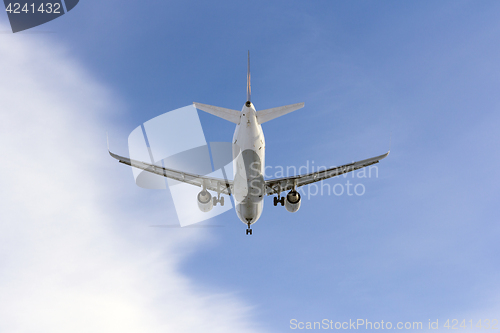 Image of Airplane flies against a background of white cloud