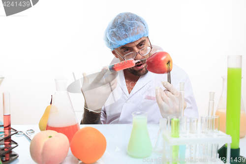 Image of scientist fills chemicals fruit and vegetables