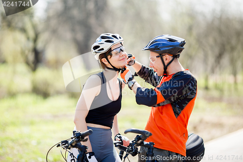 Image of Pair of bicyclists wear helmets