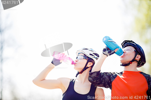 Image of Athletes drink water from bottle