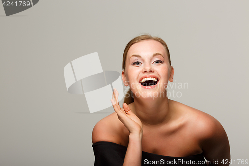 Image of Smiling woman in black dress