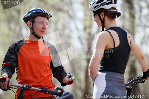 Image of Young woman, man with bicycles