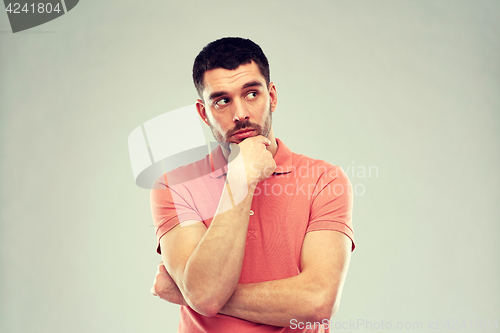 Image of man thinking over gray background