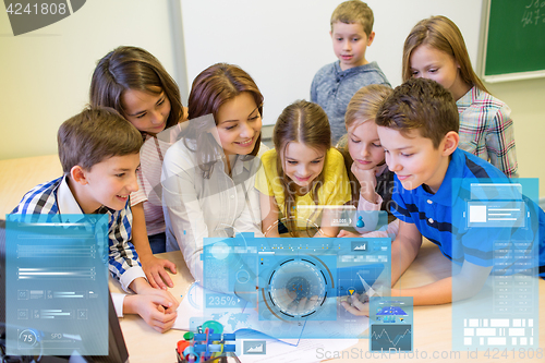 Image of group of kids with teacher and tablet pc at school