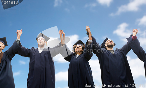 Image of happy students or bachelors celebrating graduation