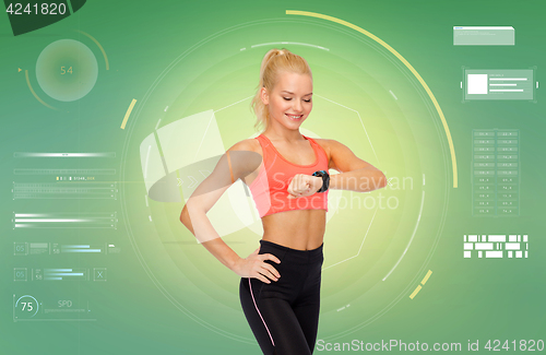 Image of smiling woman with fitness tracker or smartwatch