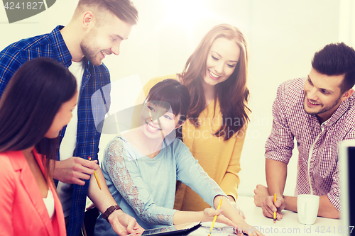 Image of happy creative team or students working at office