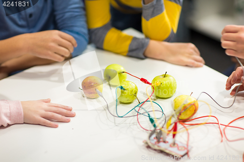 Image of kids hands with invention kit at robotics school