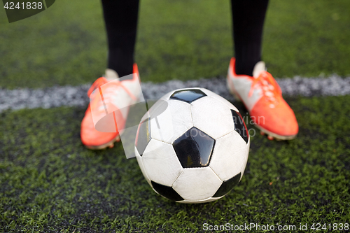 Image of soccer player playing with ball on football field