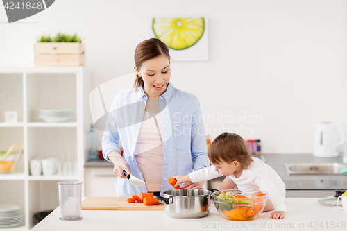 Image of happy mother and baby cooking food at home kitchen