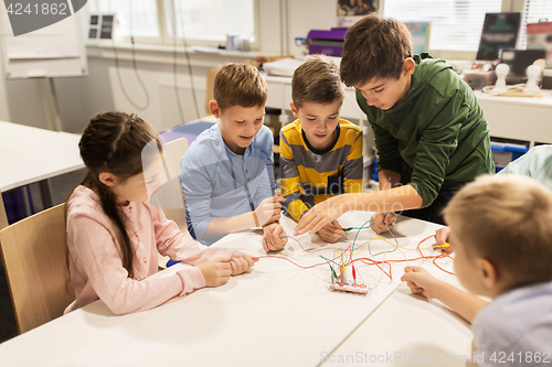 Image of happy kids with invention kit at robotics school