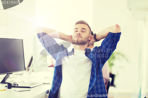 Image of happy creative man with computer at office