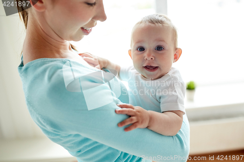 Image of happy young mother with little baby at home
