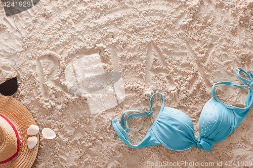 Image of Relax written in a sandy tropical beach