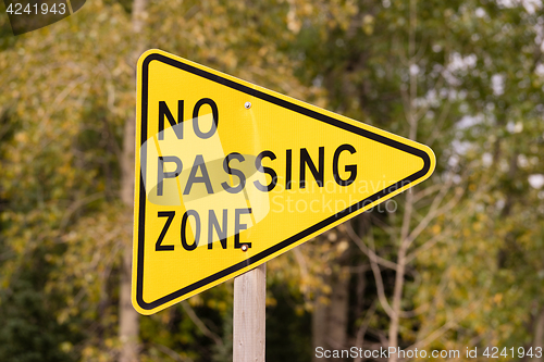 Image of Yellow Triangle Road Sign Warning No Passing Zone