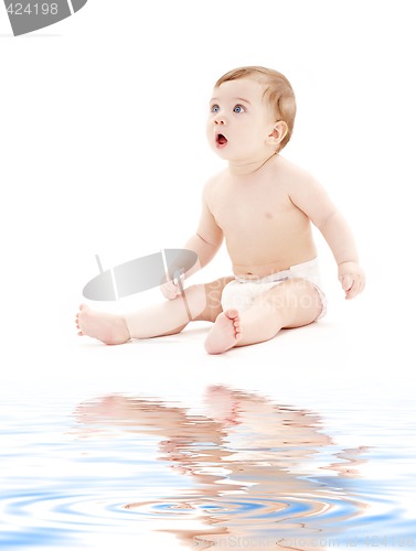 Image of baby boy in diaper with toothbrush