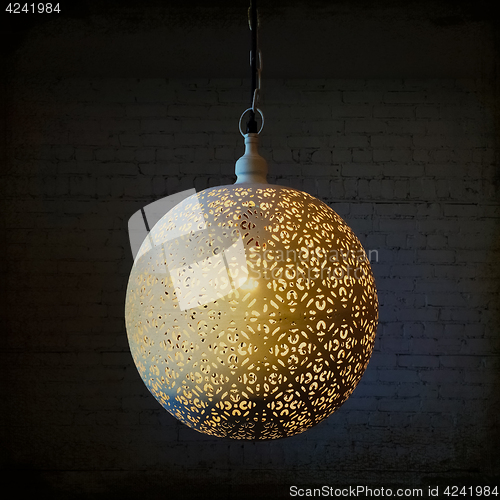 Image of Decorative metal lamp in a dark room