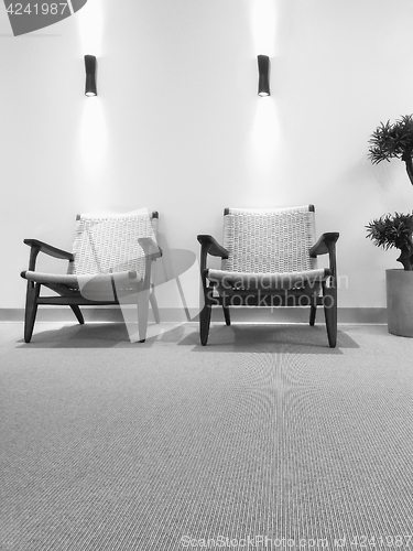 Image of Black and white interior with rattan chairs