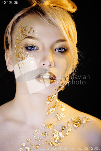 Image of beauty blond woman with gold creative make up