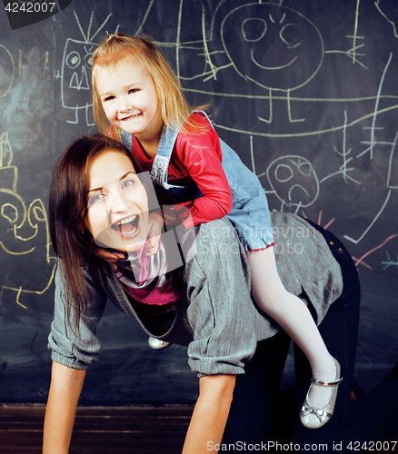 Image of mother with little daughter in classroom playing together, happy family concept, lifestyle people