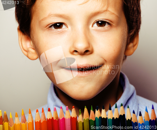 Image of little cute boy with color pencils close up smiling, education f