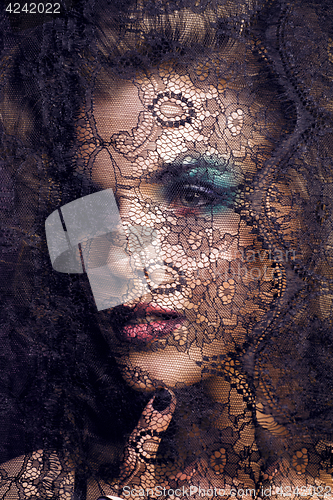 Image of portrait of beauty young woman through lace close up mistery mak