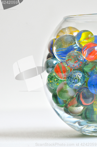 Image of glass marbles in transparent bowl