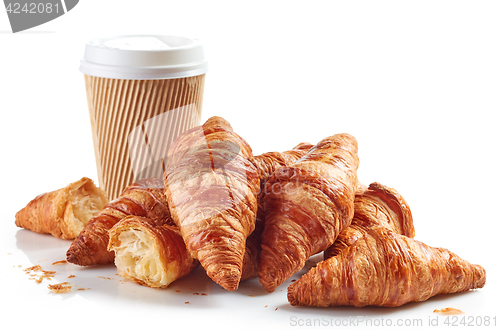 Image of heap of croissants and paper coffee cup