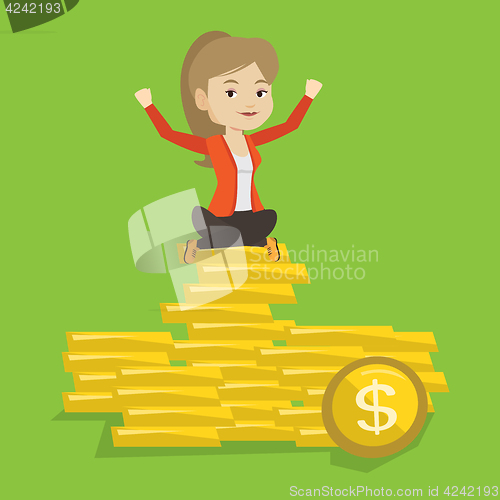 Image of Happy business woman sitting on golden coins.