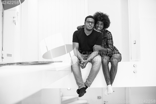 Image of couple having break during moving to new house